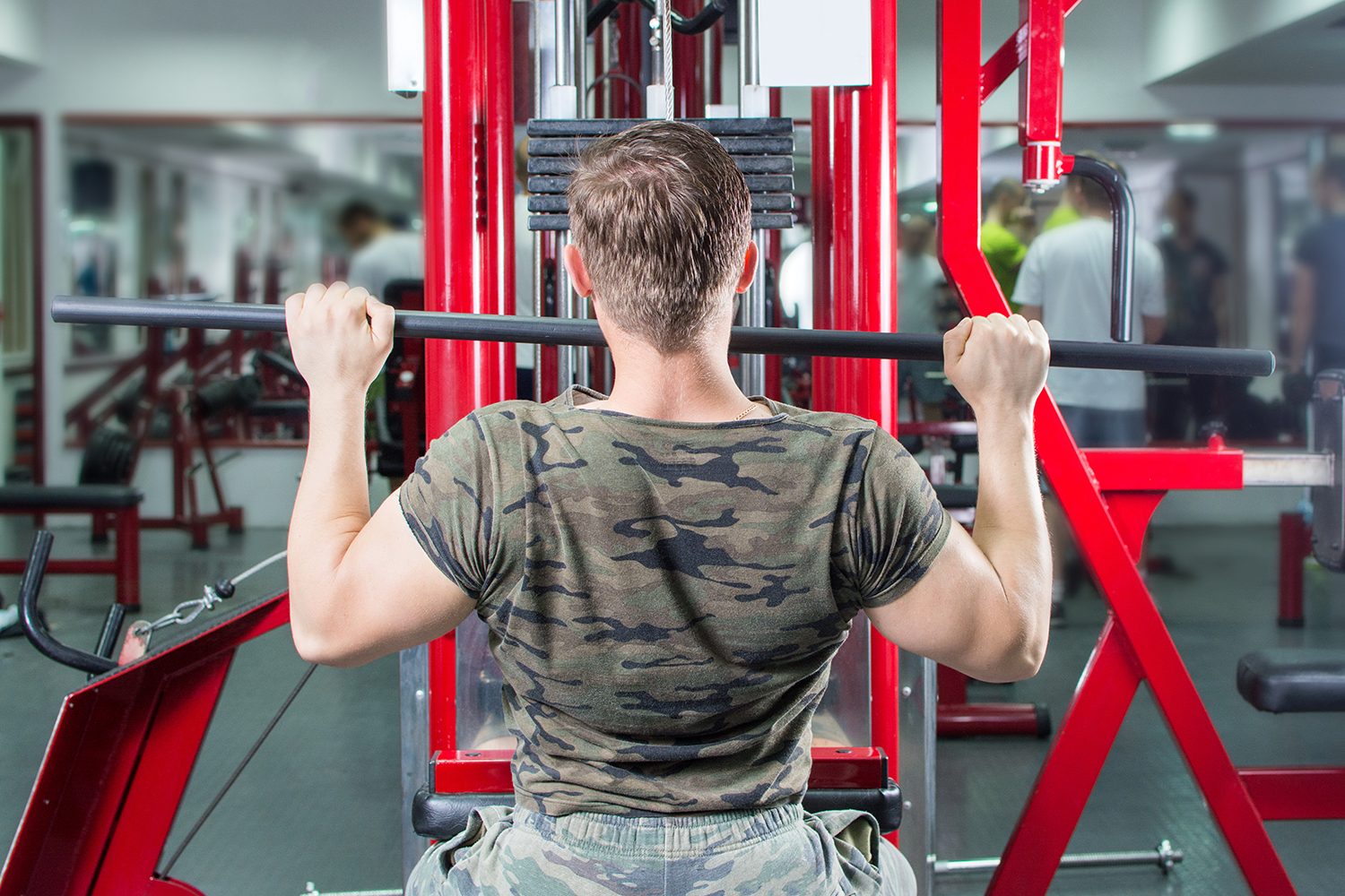 Man doing lat pull-downs.