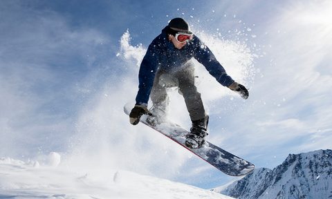 Action shot of a male snowboarding on a mountain