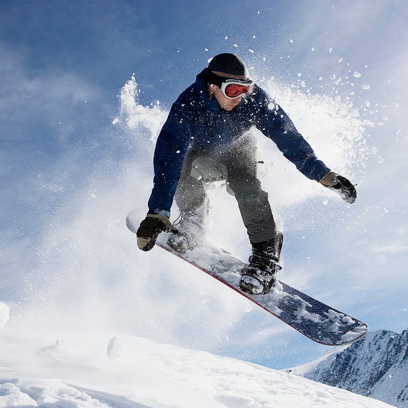 Action shot of a male snowboarding on a mountain