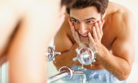 best skincare cyber monday sales 2022 happy young guy washing his face at the wash basin