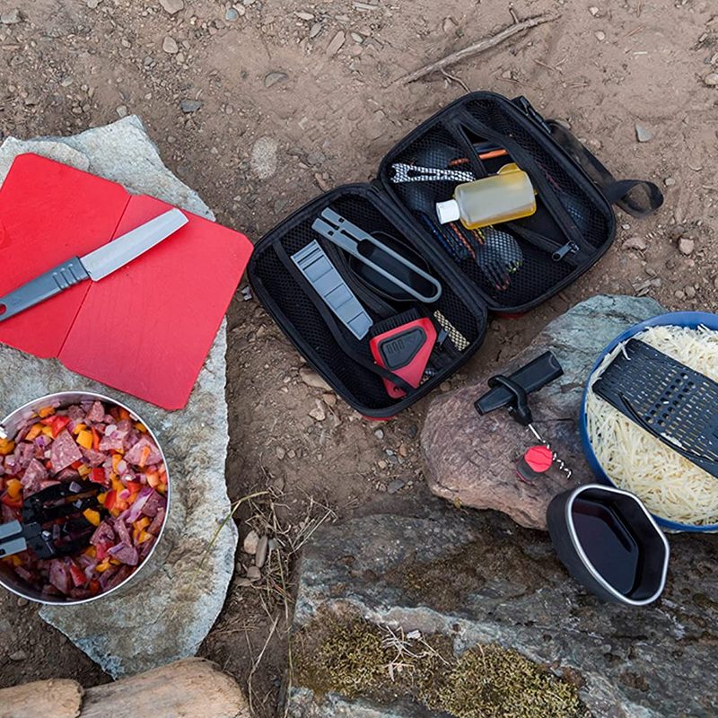 MSR Alpine Deluxe Cutting Board and a bunch of kitchen accessories on the ground.