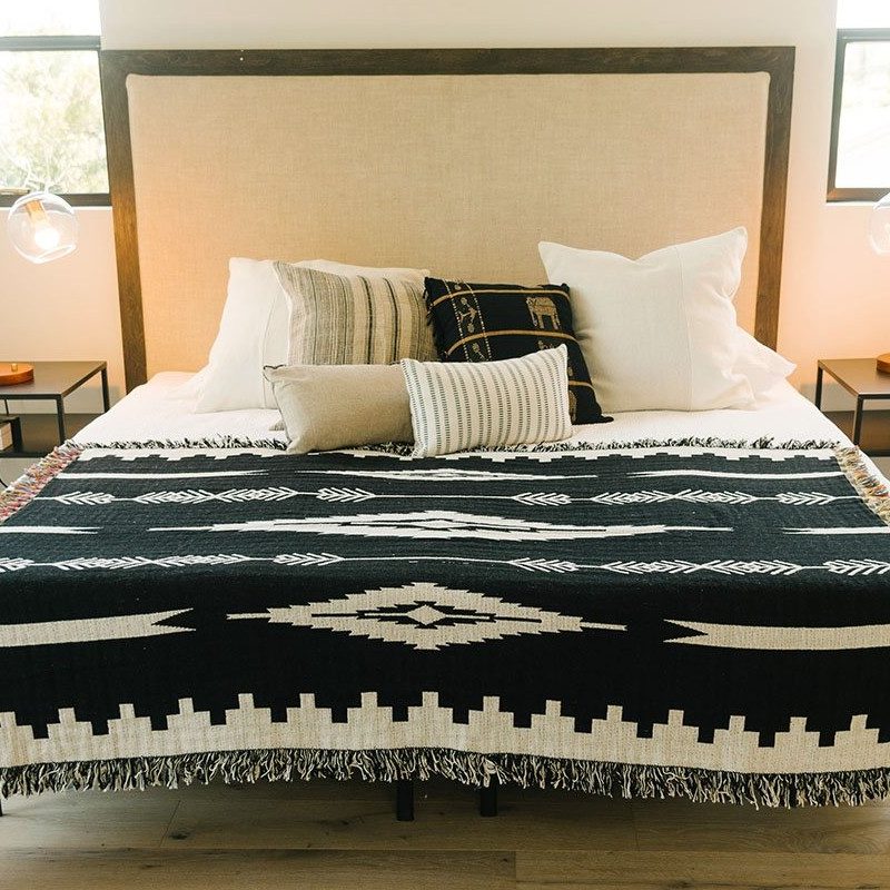 Slowtide Jericho Blanket on a bed inside a bedroom.