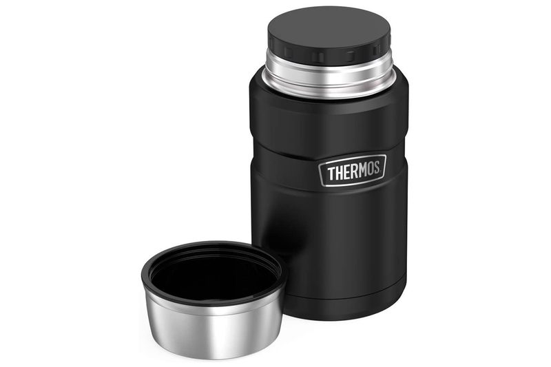 A black Thermos Stainless King Food Jar beside its bowl lid.