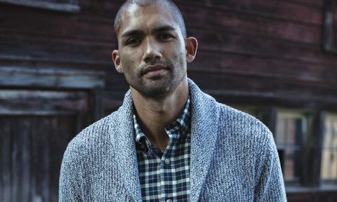 Man in a plaid shirt and cardigan