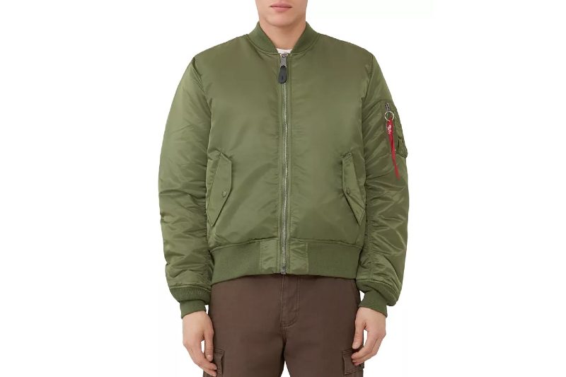 A green Alpha Industries MA-1 Bomber Jacket on a model. 