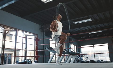 Man jumping rope inside a gym