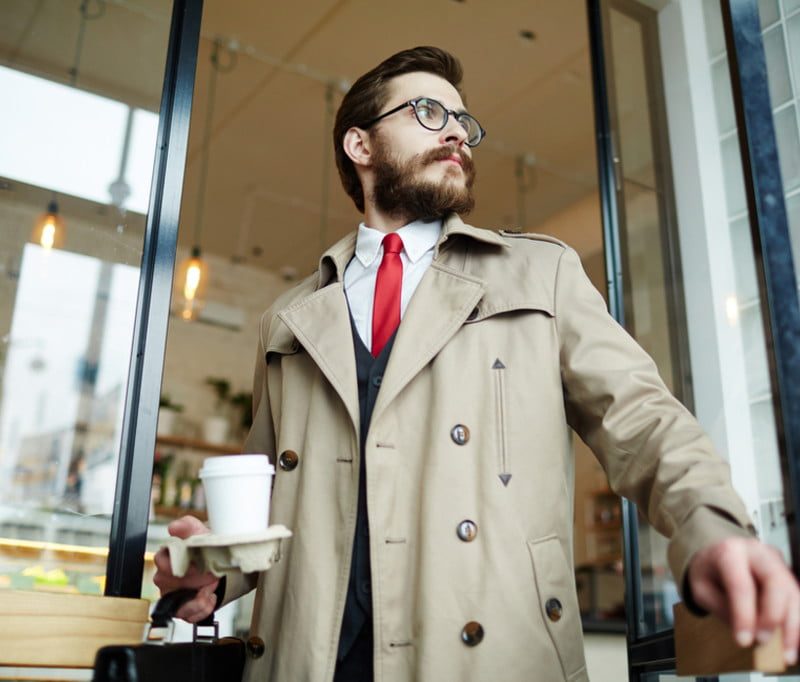 man in trench coat leaving coffee shop