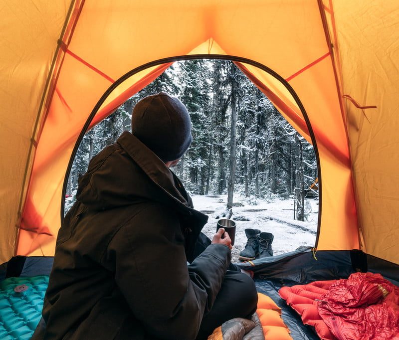 Person sitting inside a tent