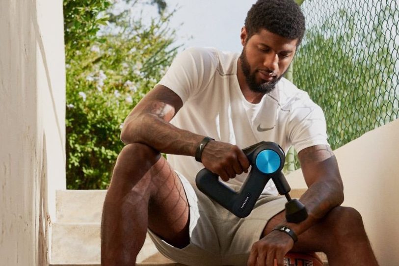 Using a massage gun.