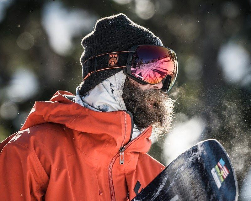 Snowboarding man wearing Spy Optic Snow Goggles.