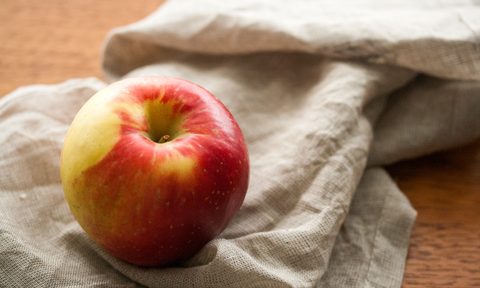 A Sweetango Apple placed on a piece of cloth.