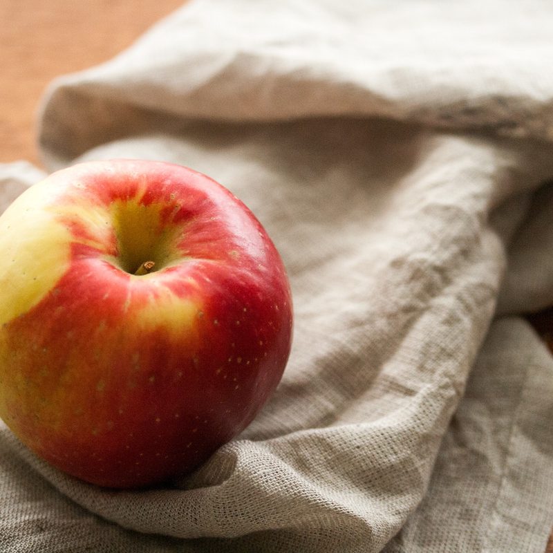 A Sweetango Apple placed on a piece of cloth.