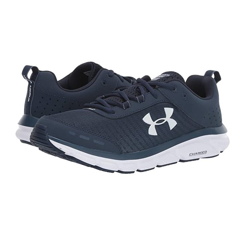 A pair of Under Armour UA Charged Assert 8 in a hite backdrop.