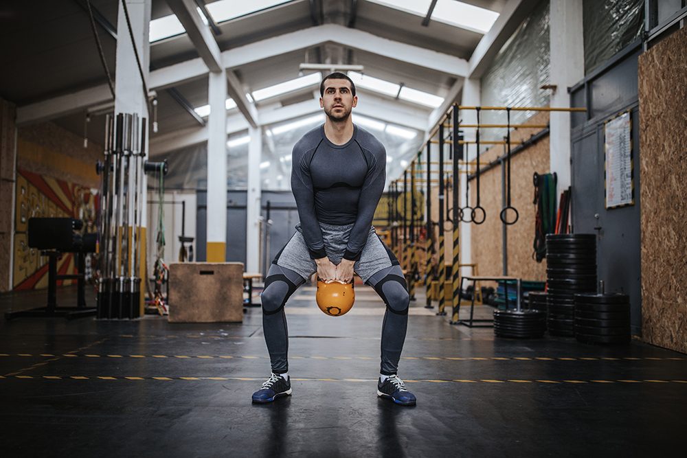Man swinging a kettlebell