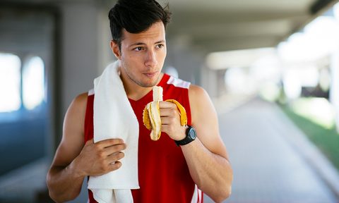 Man eating a banana before a run