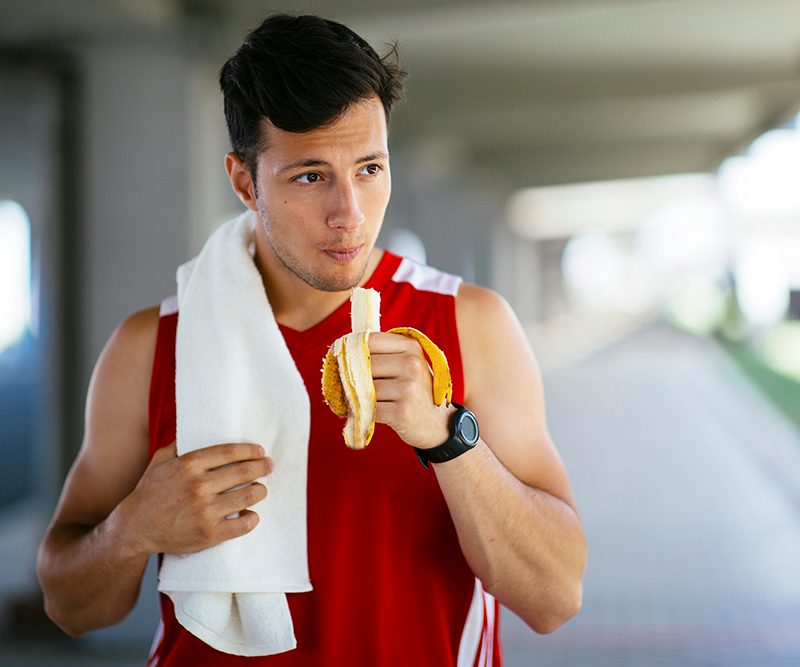 Man eating a banana before a run