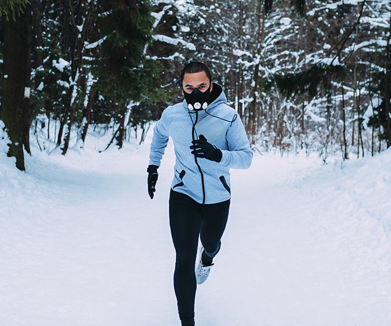 Man running on snow-covered field