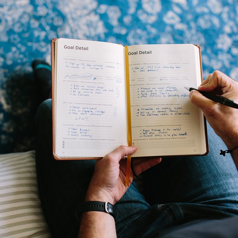 A man setting his schedule on a notebook.