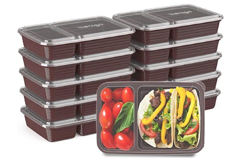 A Bentgo Prep 2-Compartment Container containing food is placed in front of two stacks of Bentgo food containers.