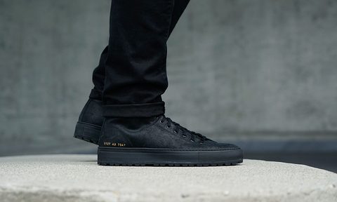 Someone wearing some Common Projects shoes.