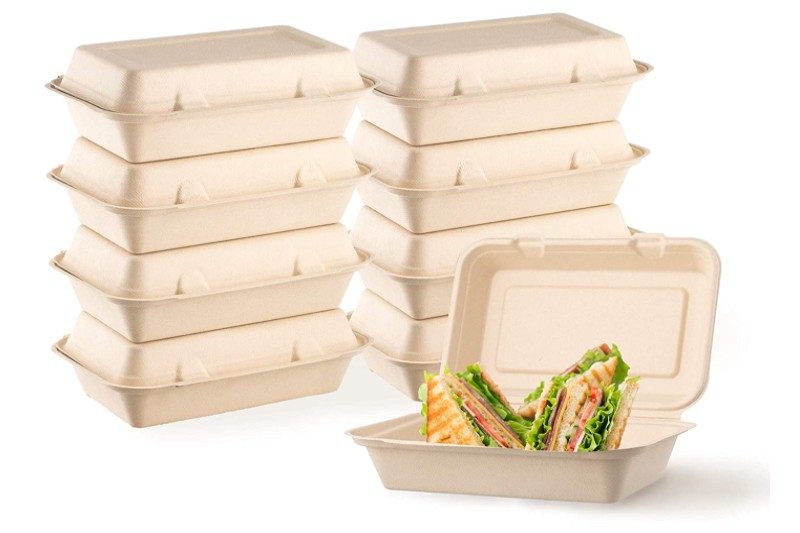 A stack of Harvest Pack Eco-Containers placed behind a Harvest Pack Eco-Container with sandwich.