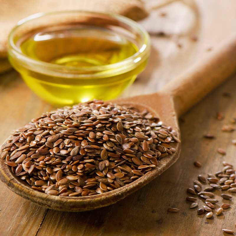 Flaxseeds in a spoon with oil