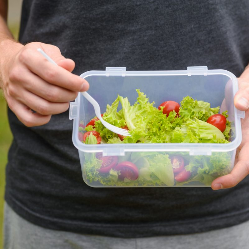 Man holding a salad.