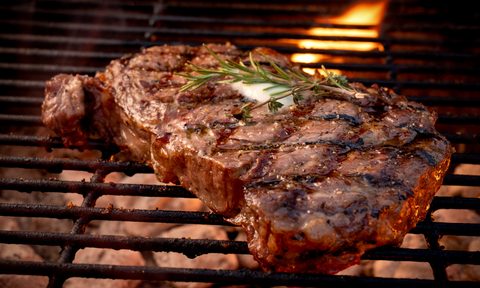Large steak on an open grill