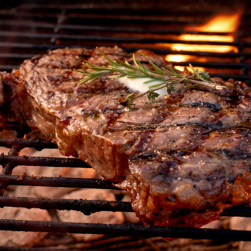 Large steak on an open grill