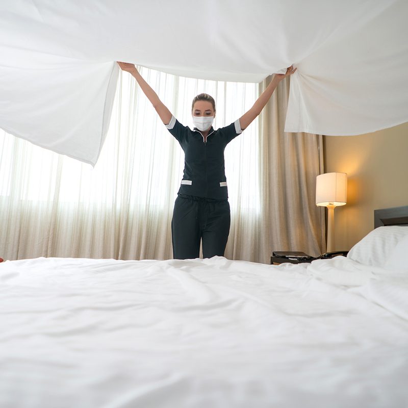 Changing hotel sheets.