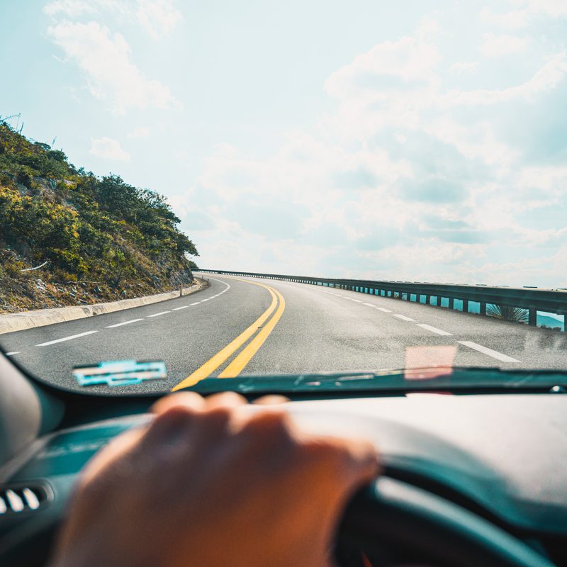 Personal perspective of person driving on mountain road