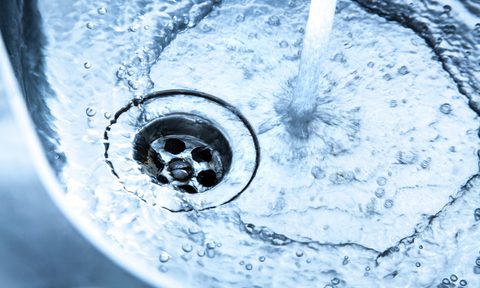 Stainless steel kitchen sink with running water