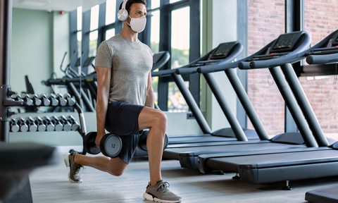 spotify workout playlist man weight training headphones