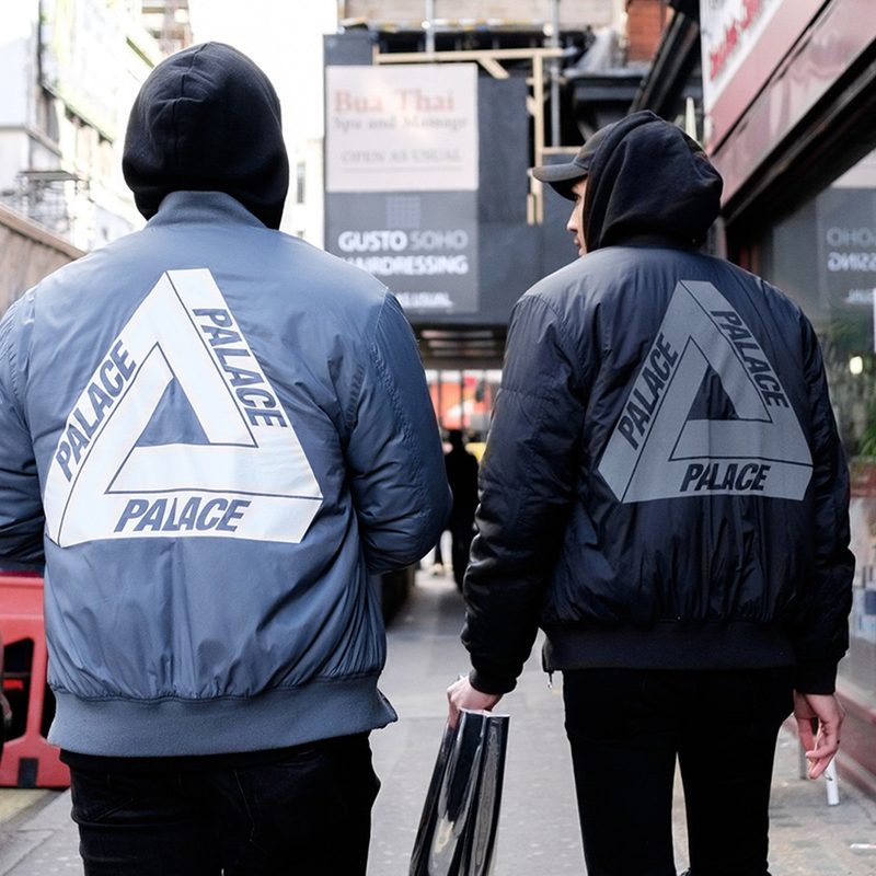 Two men wearing Palace jackets on the street