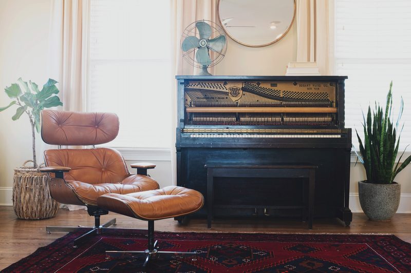 Example of global interior design style piano and leather chair