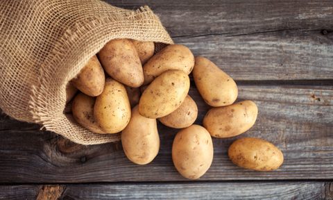 A sack of potatoes on a wooden table