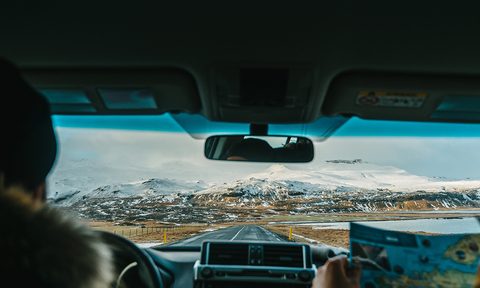 Interior view of man driving car.