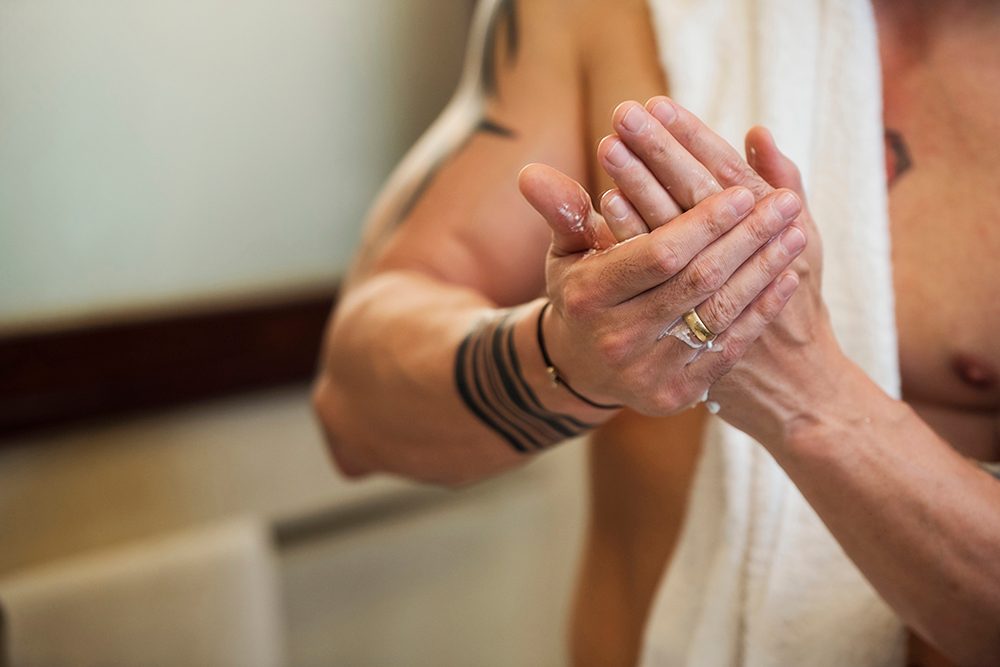 best lotions for tattoos man applying hand cream