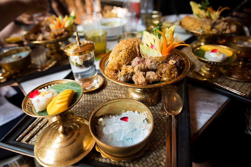 A set of Traditional Thai food Khao Chae on brass bowls and platters