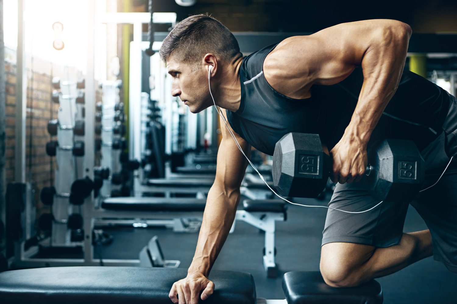 dumbbell Man doing an arm workout in the gym