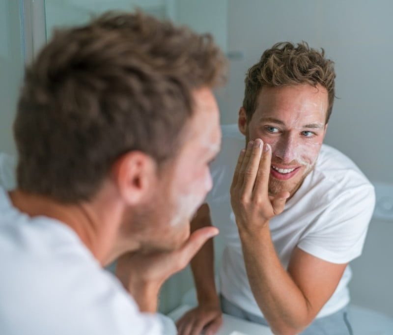 Man exfoliating his skin