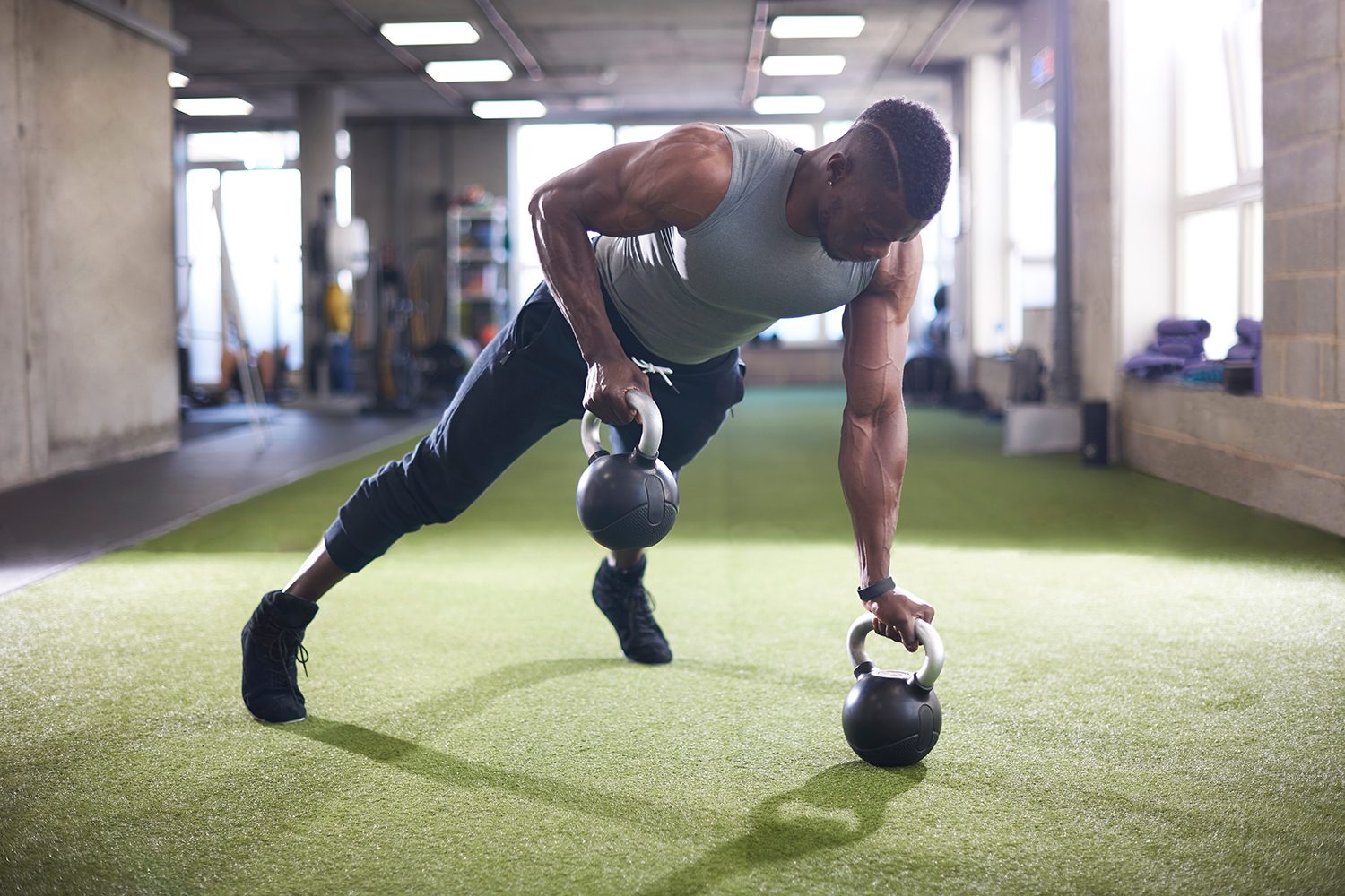 Man using kettlebells.