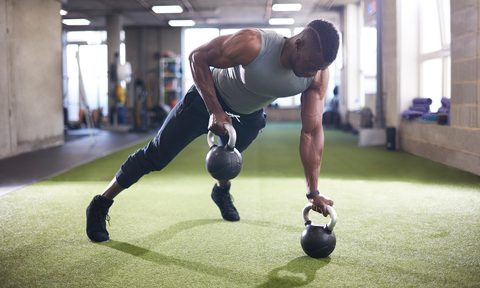 Man using kettlebells.