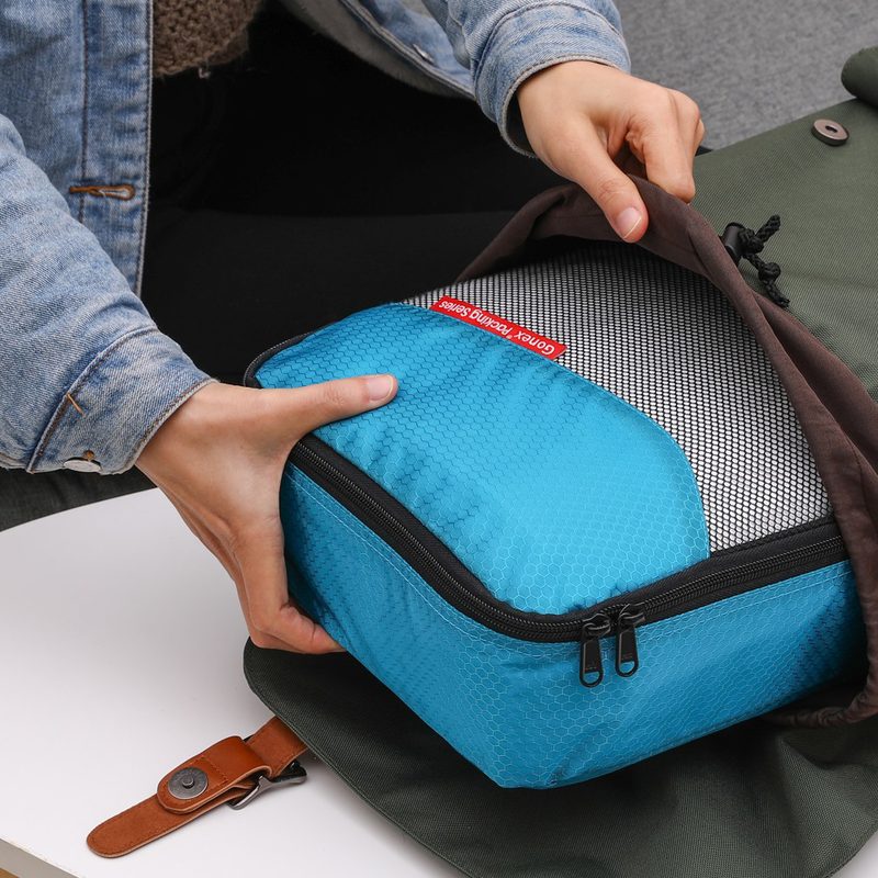 A person using a packing cube