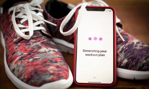 Workout app on a phone with running shoes