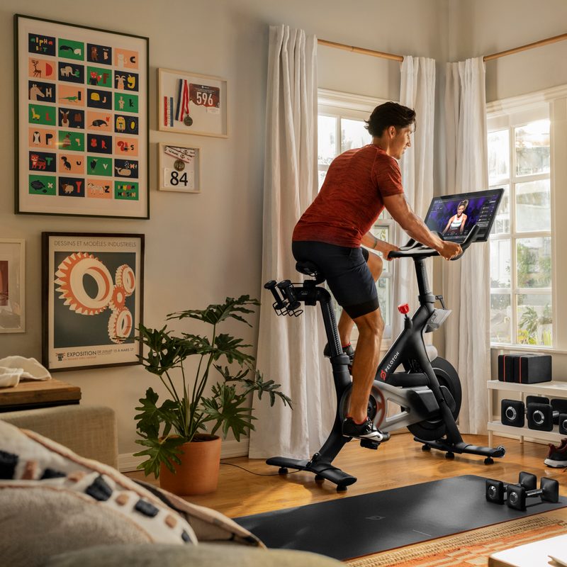 Cyclist on a Peloton in living room.