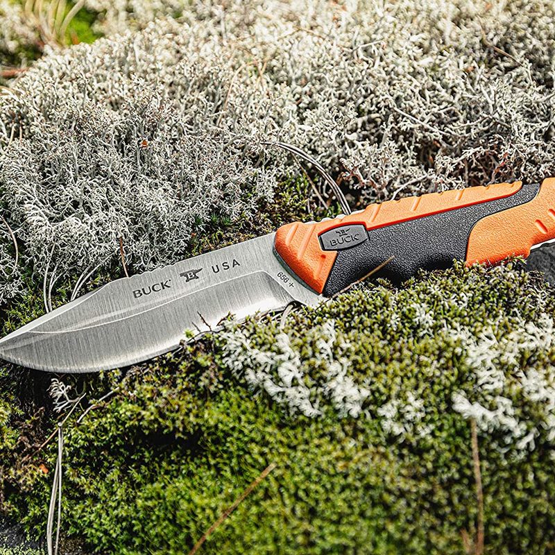 Buck 656 Pursuit Pro Hunting Knife on a rock in the woods.