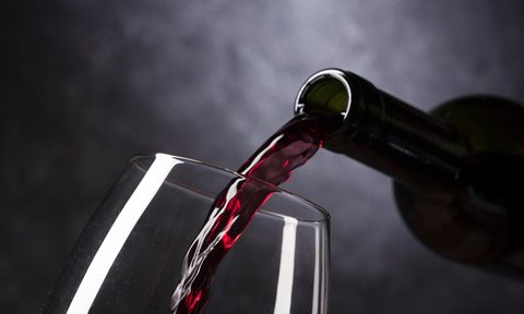 Red wine pouring into a glass