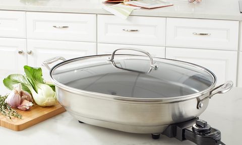 Stainless electric skillet on a kitchen countertop.