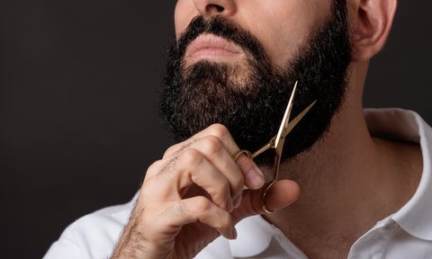 best beard grooming kits midsection of man trimming against black background
